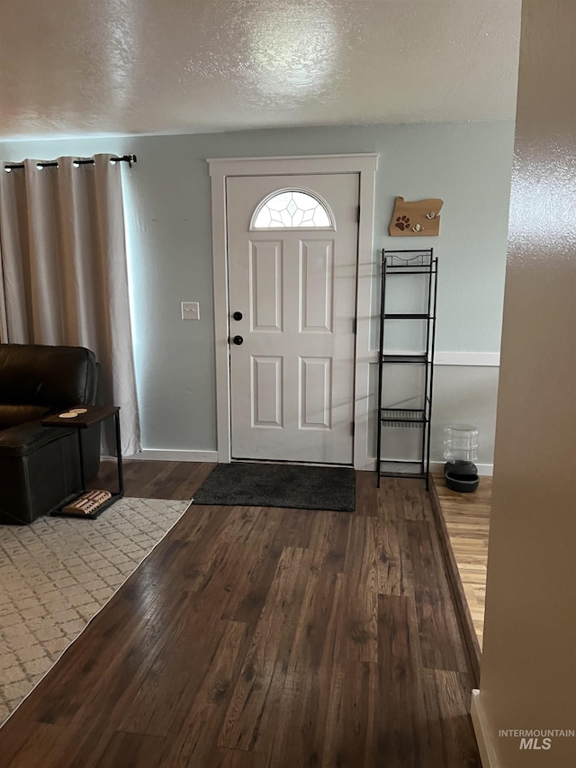 foyer with hardwood / wood-style flooring and a textured ceiling