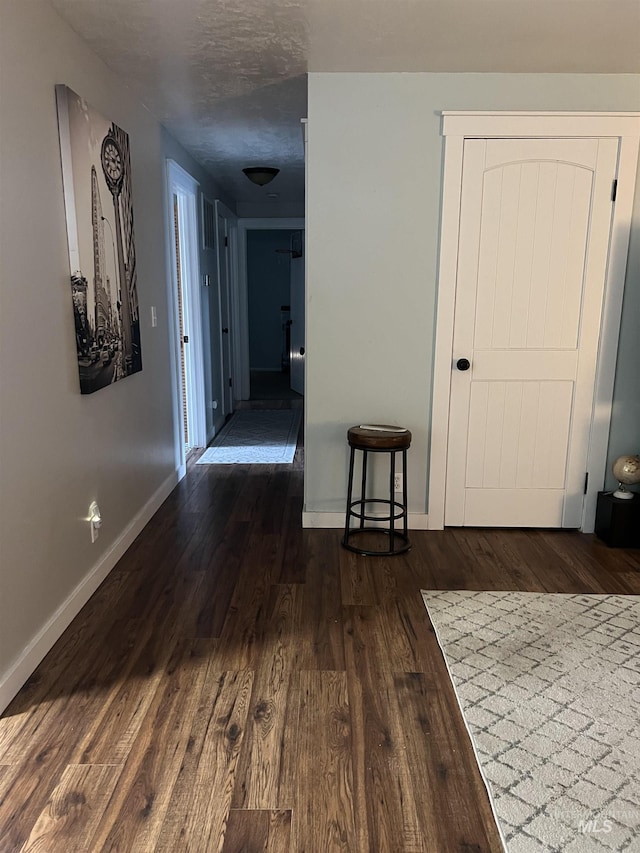 hallway with dark hardwood / wood-style floors