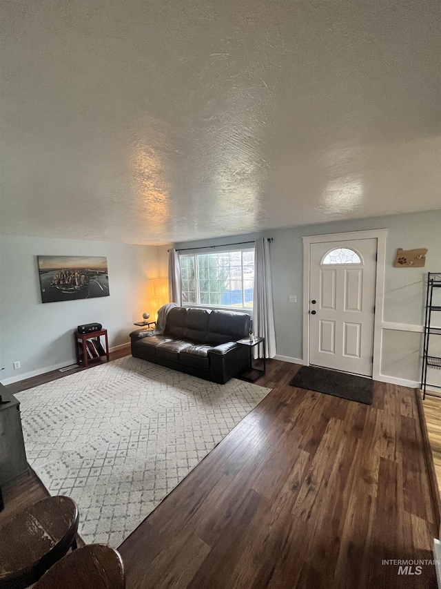 living room featuring hardwood / wood-style flooring and a textured ceiling