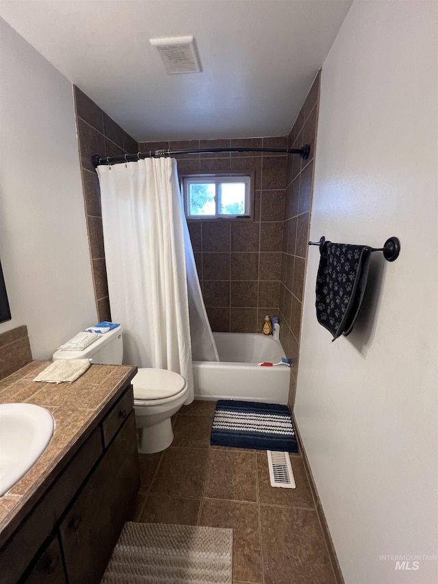 full bathroom with vanity, shower / bath combo, and toilet