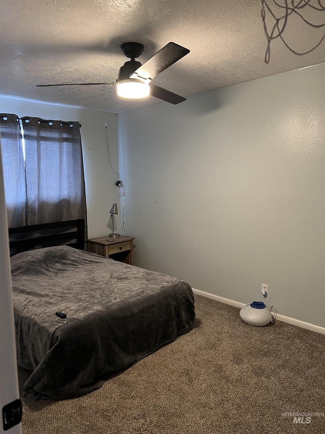 carpeted bedroom with a textured ceiling and ceiling fan