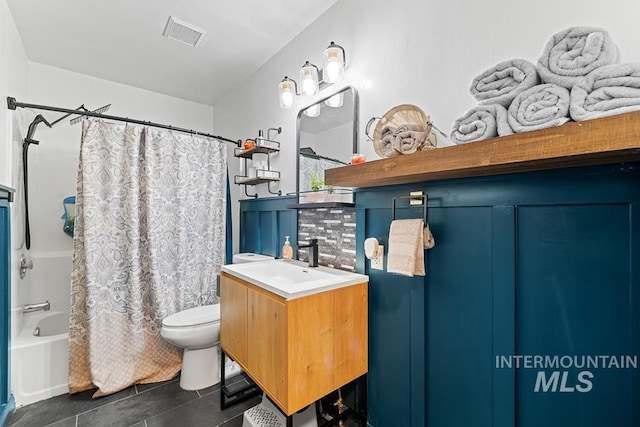 full bathroom with vanity, tasteful backsplash, tile patterned flooring, toilet, and shower / bath combo with shower curtain