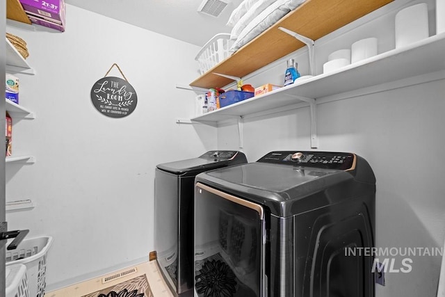 laundry room with washing machine and clothes dryer