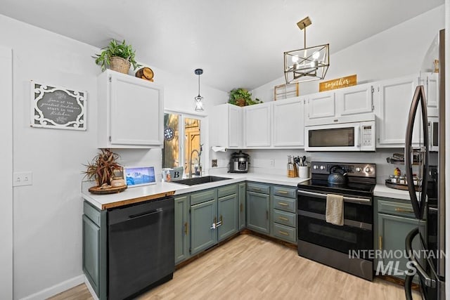 kitchen featuring vaulted ceiling, black dishwasher, stainless steel electric range oven, sink, and light wood-type flooring