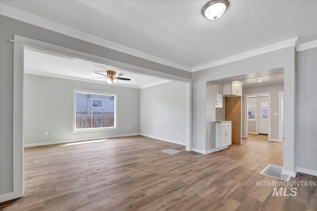 414 Yakima Ave, Filer, ID 83328 - unfurnished living room featuring light wood-style flooring, crown molding, and ceiling fan