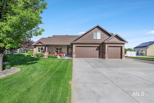 45 Ridge Loop, Jerome, ID 83338 - craftsman-style house with concrete driveway, a front lawn, stone siding, stucco siding, and an attached garage