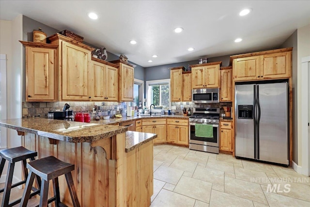 45 Ridge Loop, Jerome, ID 83338 - kitchen with appliances with stainless steel finishes, a peninsula, backsplash, recessed lighting, and light brown cabinetry