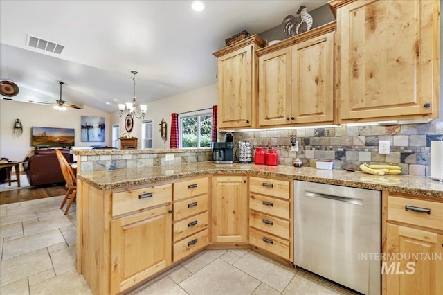 45 Ridge Loop, Jerome, ID 83338 - kitchen featuring stainless steel dishwasher, light brown cabinets, a peninsula, decorative backsplash, and vaulted ceiling