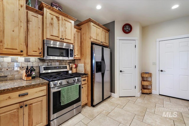 45 Ridge Loop, Jerome, ID 83338 - kitchen featuring stainless steel appliances, decorative backsplash, dark stone countertops, light brown cabinets, and recessed lighting