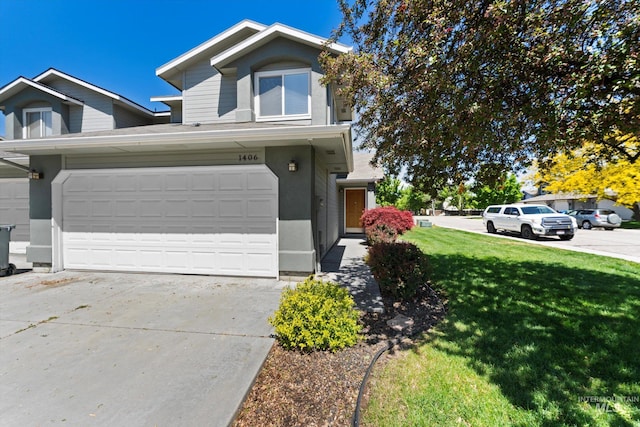 1406 W Wright St, Boise, ID 83705 - view of front of house with driveway, a front lawn, a garage, and stucco siding