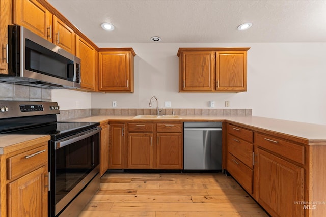 1406 W Wright St, Boise, ID 83705 - kitchen with stainless steel appliances, a sink, a peninsula, light countertops, and recessed lighting
