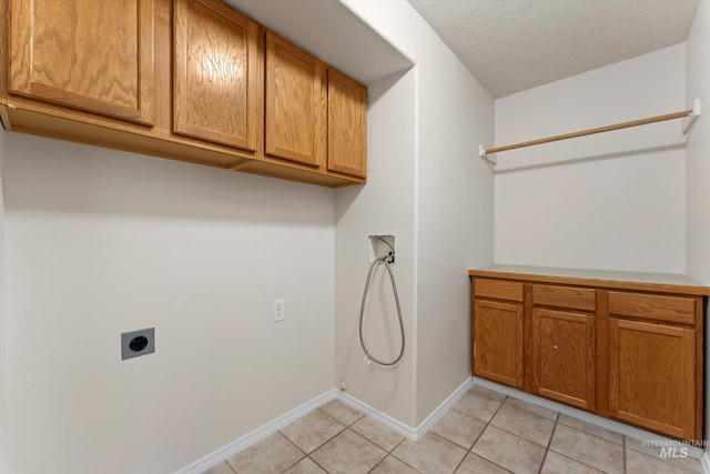 1406 W Wright St, Boise, ID 83705 - laundry area with electric dryer hookup, washer hookup, cabinet space, baseboards, and light tile patterned flooring