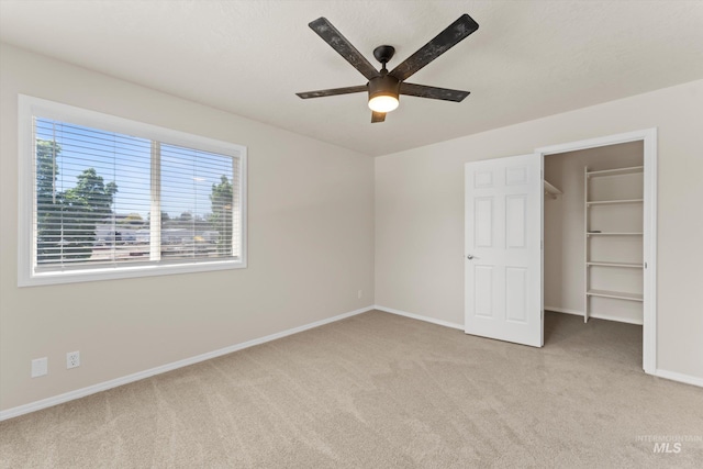 1406 W Wright St, Boise, ID 83705 - unfurnished bedroom with light carpet, a spacious closet, baseboards, a ceiling fan, and a closet