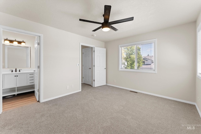 1406 W Wright St, Boise, ID 83705 - unfurnished bedroom featuring carpet, baseboards, connected bathroom, and a ceiling fan