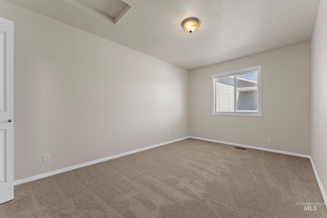 1406 W Wright St, Boise, ID 83705 - carpeted spare room with baseboards, a textured ceiling, and attic access