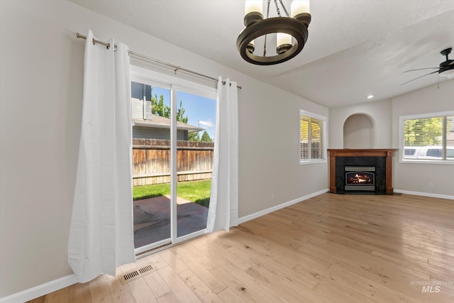 1406 W Wright St, Boise, ID 83705 - unfurnished living room featuring a chandelier, wood finished floors, a ceiling fan, and baseboards