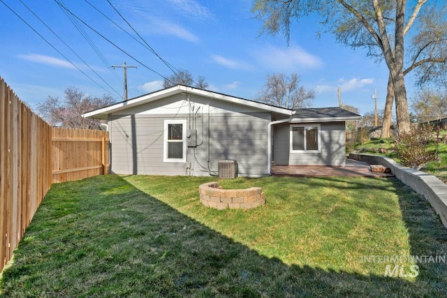 rear view of property featuring cooling unit, a fenced backyard, a patio, and a yard