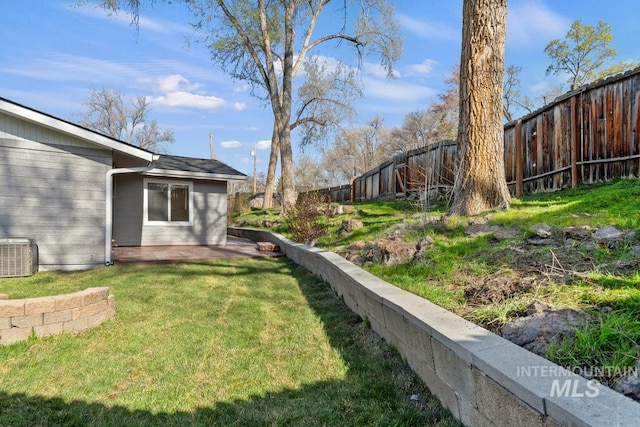 view of yard with a fenced backyard, cooling unit, and a patio