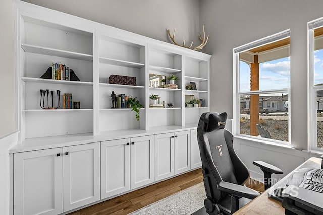 office area with plenty of natural light and dark wood-type flooring