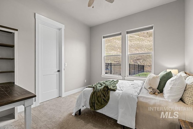 bedroom featuring carpet, baseboards, and ceiling fan