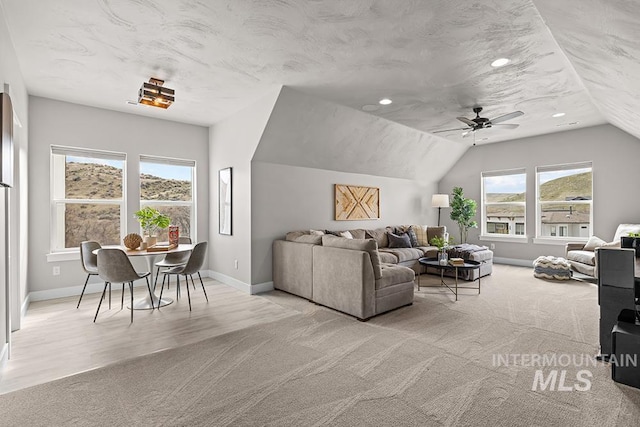 living area featuring light carpet, a ceiling fan, recessed lighting, baseboards, and vaulted ceiling