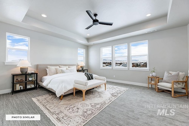 bedroom featuring a tray ceiling, carpet, visible vents, and recessed lighting