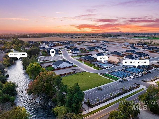 aerial view at dusk featuring a residential view