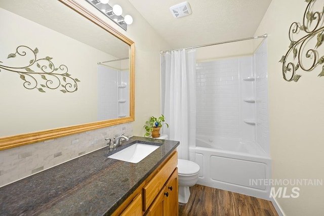 2189 W Rainfall St, Meridian, ID 83646 - full bathroom with wood finished floors, backsplash, toilet, vanity, and shower / bath combo