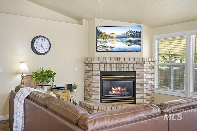 2189 W Rainfall St, Meridian, ID 83646 - living area with a fireplace, lofted ceiling, baseboards, and wood finished floors