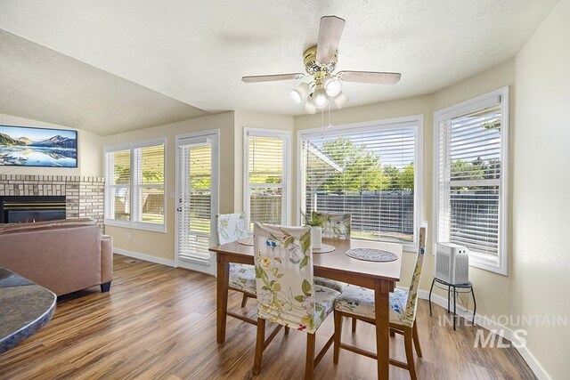 2189 W Rainfall St, Meridian, ID 83646 - dining room featuring baseboards, wood finished floors, healthy amount of natural light, ceiling fan, and a textured ceiling