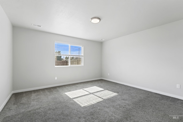 unfurnished room featuring carpet flooring, baseboards, and visible vents