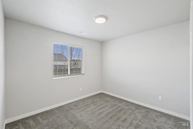 empty room with visible vents, carpet floors, and baseboards