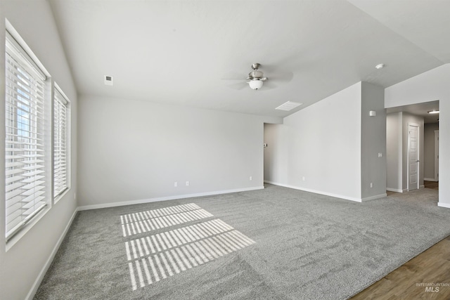 unfurnished room with baseboards, lofted ceiling, carpet, and a ceiling fan