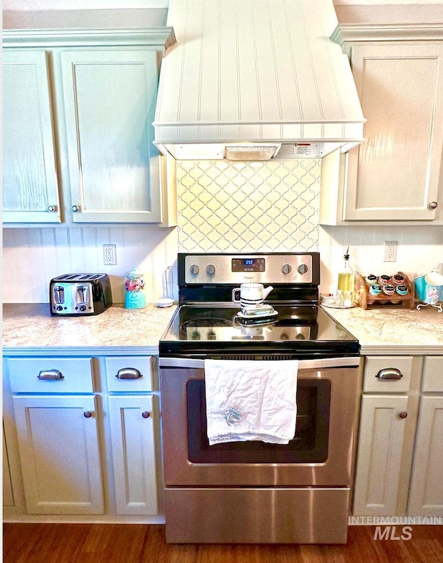 3617 Rubicon St, New Meadows, ID 83612 - kitchen featuring stainless steel range with electric cooktop, premium range hood, light countertops, and dark wood finished floors