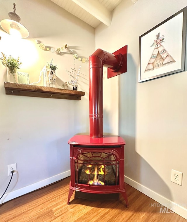 3617 Rubicon St, New Meadows, ID 83612 - detailed view of wood finished floors, a wood stove, and baseboards