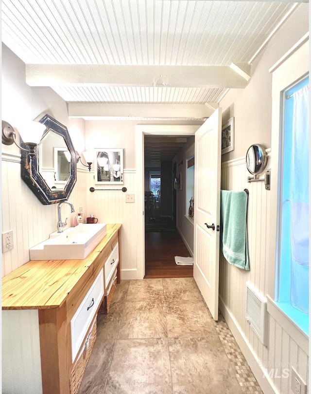 3617 Rubicon St, New Meadows, ID 83612 - full bathroom featuring vanity, wood ceiling with exposed beams, wainscoting, and wood walls