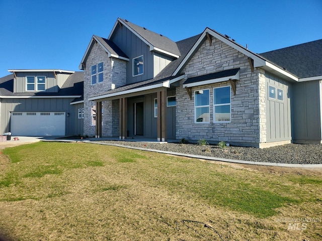 view of front of property with a porch, a garage, and a front yard