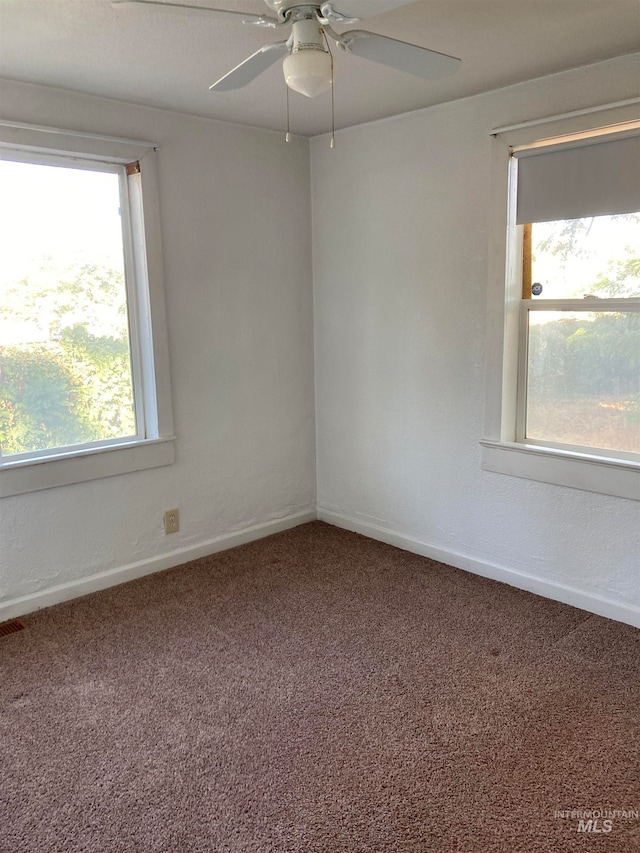 carpeted spare room with ceiling fan