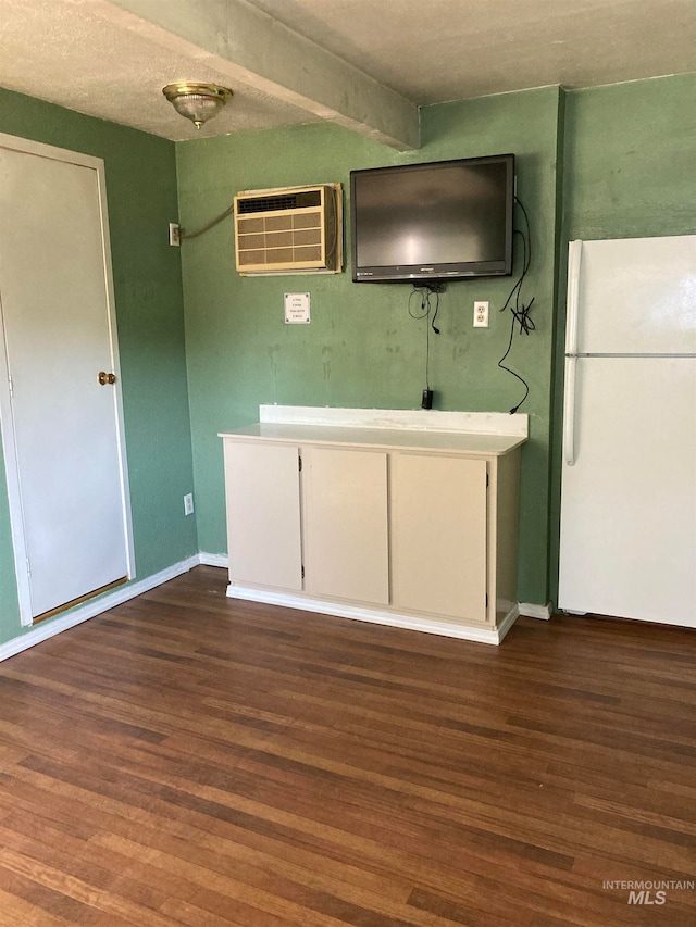 kitchen featuring white cabinets, white refrigerator, dark hardwood / wood-style floors, and a wall mounted AC