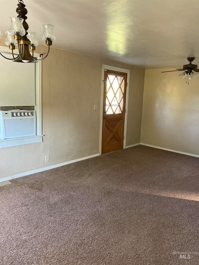 unfurnished room with ceiling fan with notable chandelier, cooling unit, and carpet