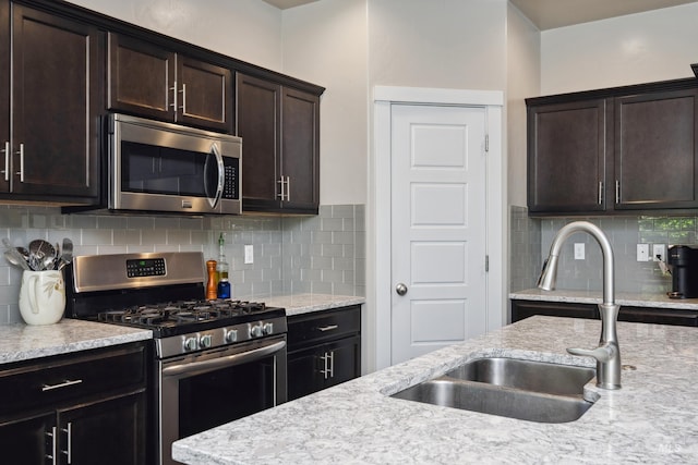 12022 W Ardyce, Boise, ID 83713 - kitchen with stainless steel appliances, dark brown cabinetry, and backsplash