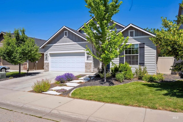 12022 W Ardyce, Boise, ID 83713 - view of front of property with board and batten siding, a garage, concrete driveway, a front yard, and stone siding