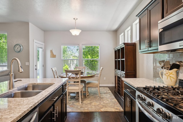 12022 W Ardyce, Boise, ID 83713 - kitchen featuring appliances with stainless steel finishes, plenty of natural light, dark wood-style floors, and dark brown cabinets