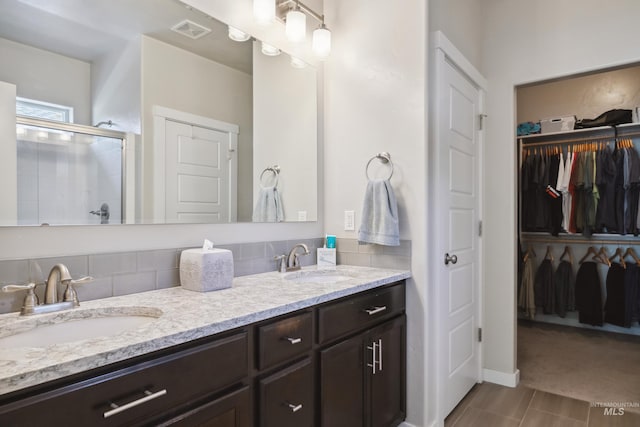 12022 W Ardyce, Boise, ID 83713 - bathroom featuring double vanity, a walk in closet, and a stall shower