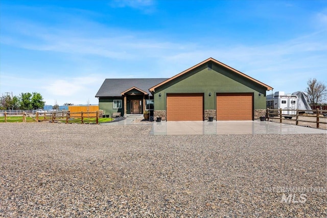 1770 N 3rd St, Nyssa, OR 97913 - ranch-style house with a garage, stucco siding, driveway, and stone siding