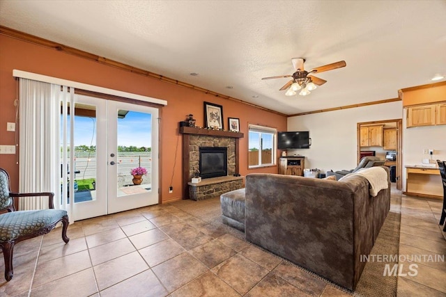 1770 N 3rd St, Nyssa, OR 97913 - tiled living room featuring a ceiling fan, ornamental molding, french doors, a fireplace, and baseboards