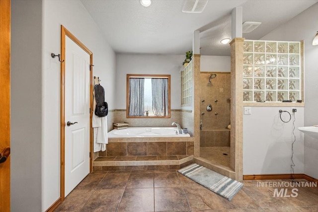 1770 N 3rd St, Nyssa, OR 97913 - full bathroom featuring a garden tub, a tile shower, and tile patterned flooring