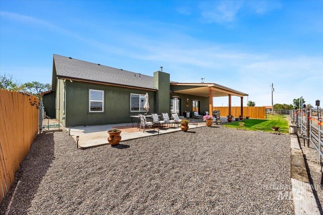 1770 N 3rd St, Nyssa, OR 97913 - rear view of property featuring a fenced backyard, a patio, stucco siding, and a shingled roof