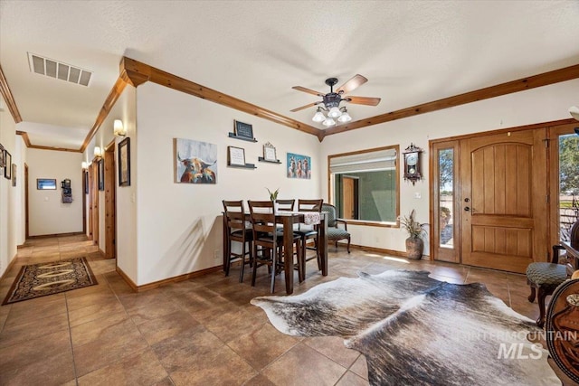 1770 N 3rd St, Nyssa, OR 97913 - dining room featuring baseboards, ceiling fan, crown molding, a textured ceiling, and tile patterned floors