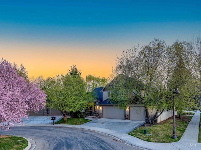 view of front of home with stone siding and driveway